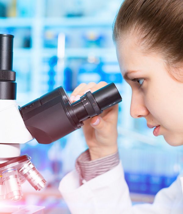 Woman looking through microscope